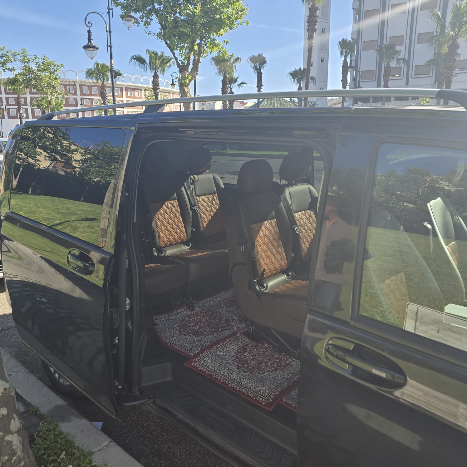 Open sliding door showing four leather passenger seats